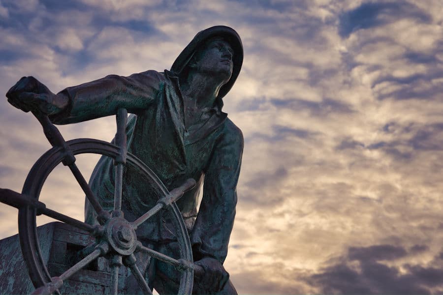 The Man at the Wheel, Gloucester's fisherman memorial, against an evening sky
