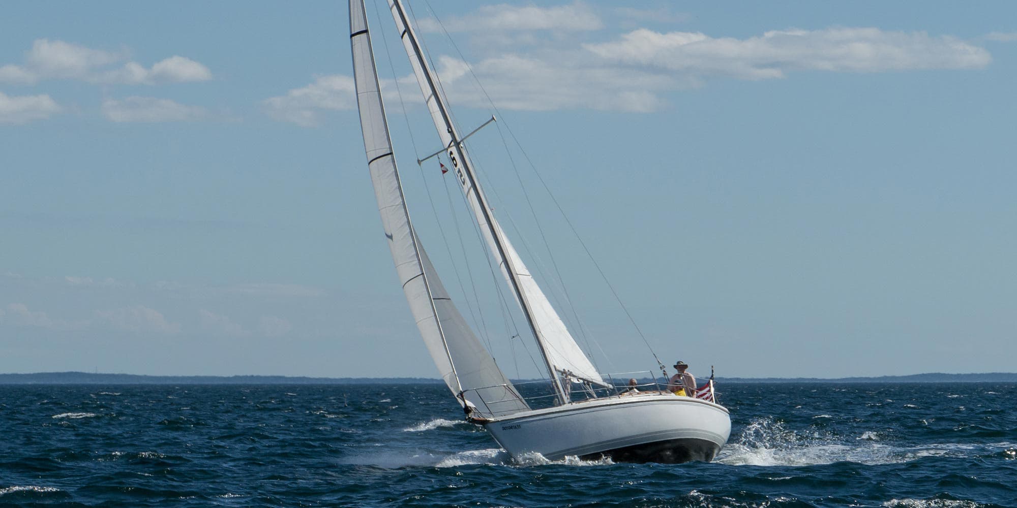 A sloop under sail on open water